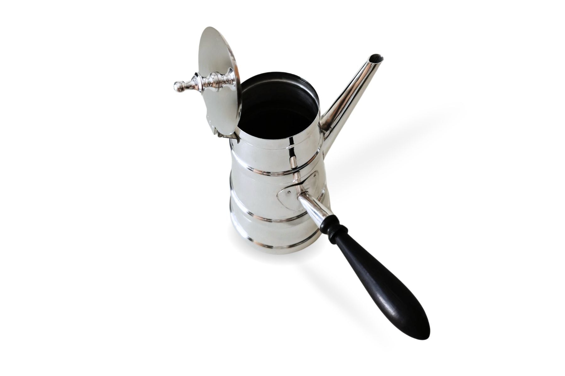 Silver Arabic coffee pot placed on traditional wooden table