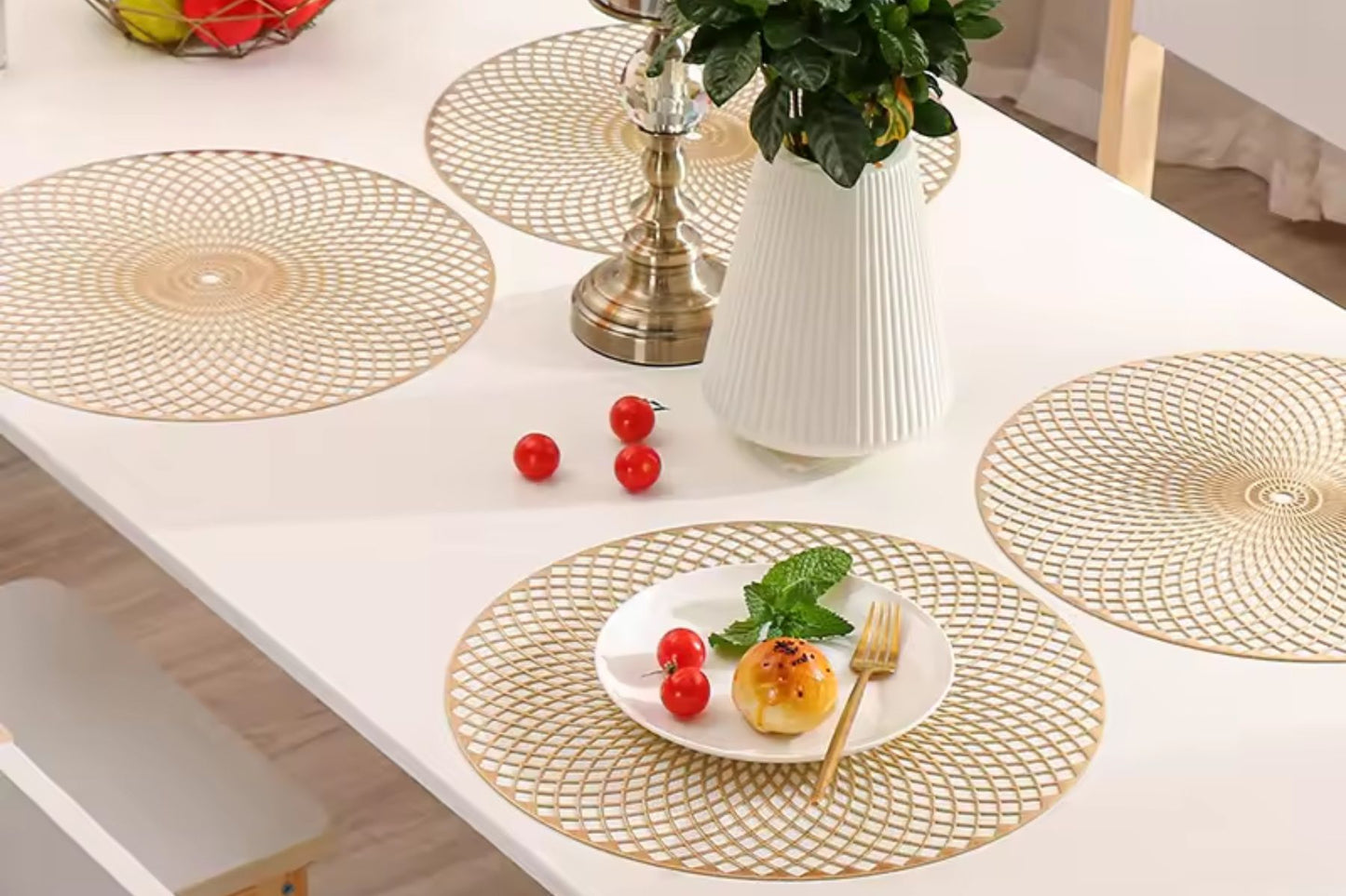Shiny round gold placemat enhancing the table setting