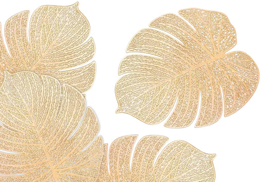 Gold leaf-shaped placemat on a decorated dining table
