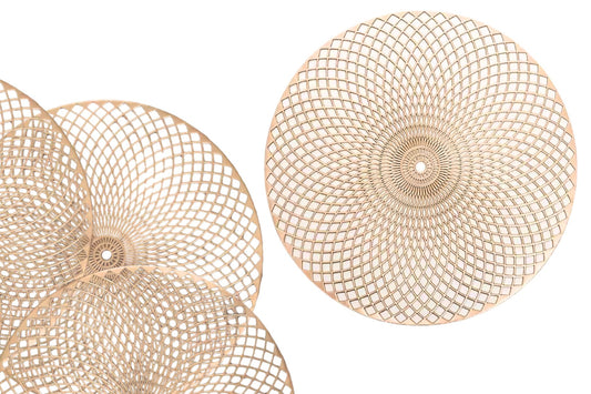 Top view of round gold placemat on dining table